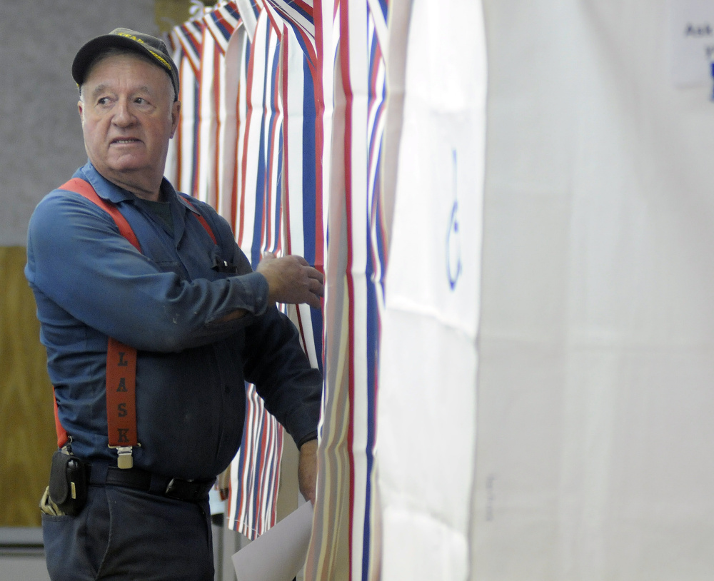 Gregory Larrabee heads into the polls June 14 to vote in Litchfield, where voters rejected the Regional School Unit 4 budget.