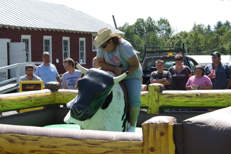 Athens Recreation Department organizer Victoria Avery rides a mechanical bull during a previous year's Family Fun Day. This year's events are set to begin at noon Saturday at the fairgrounds on Main Street.