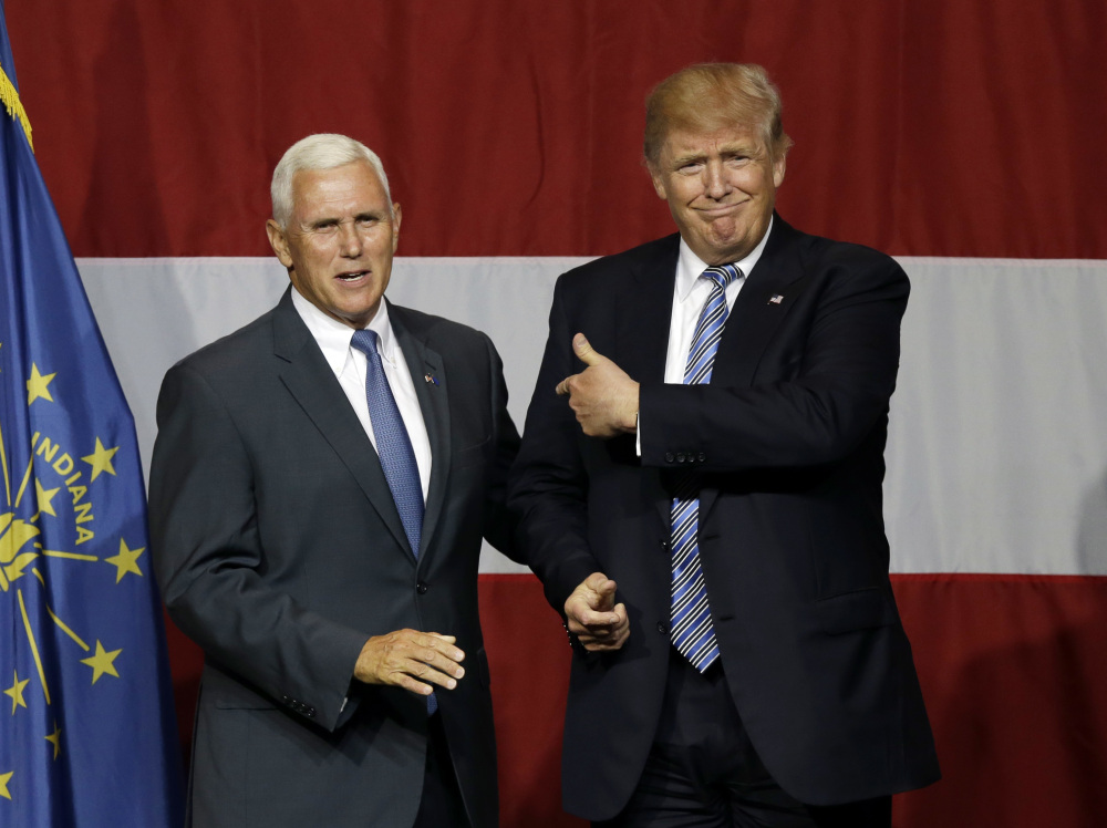 Indiana Gov. Mike Pence joins Republican presidential candidate Donald Trump at a rally in Westfield, Ind., July 12. Pence's decision to join Trump on the ticket is at odds with his previous positions.