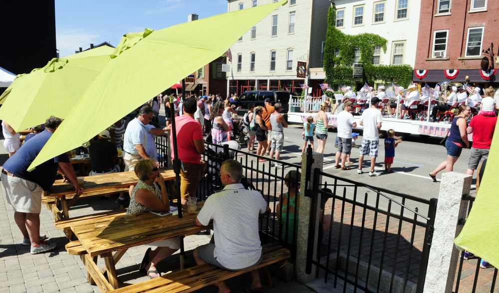 People on the Quarry Tap Room deck watch the Hallowell Community Band go by Saturday at the start of the 2016 Old Hallowell Day parade. The deck was under construction for a few weeks and was completed just in time for Old Hallowell Day.