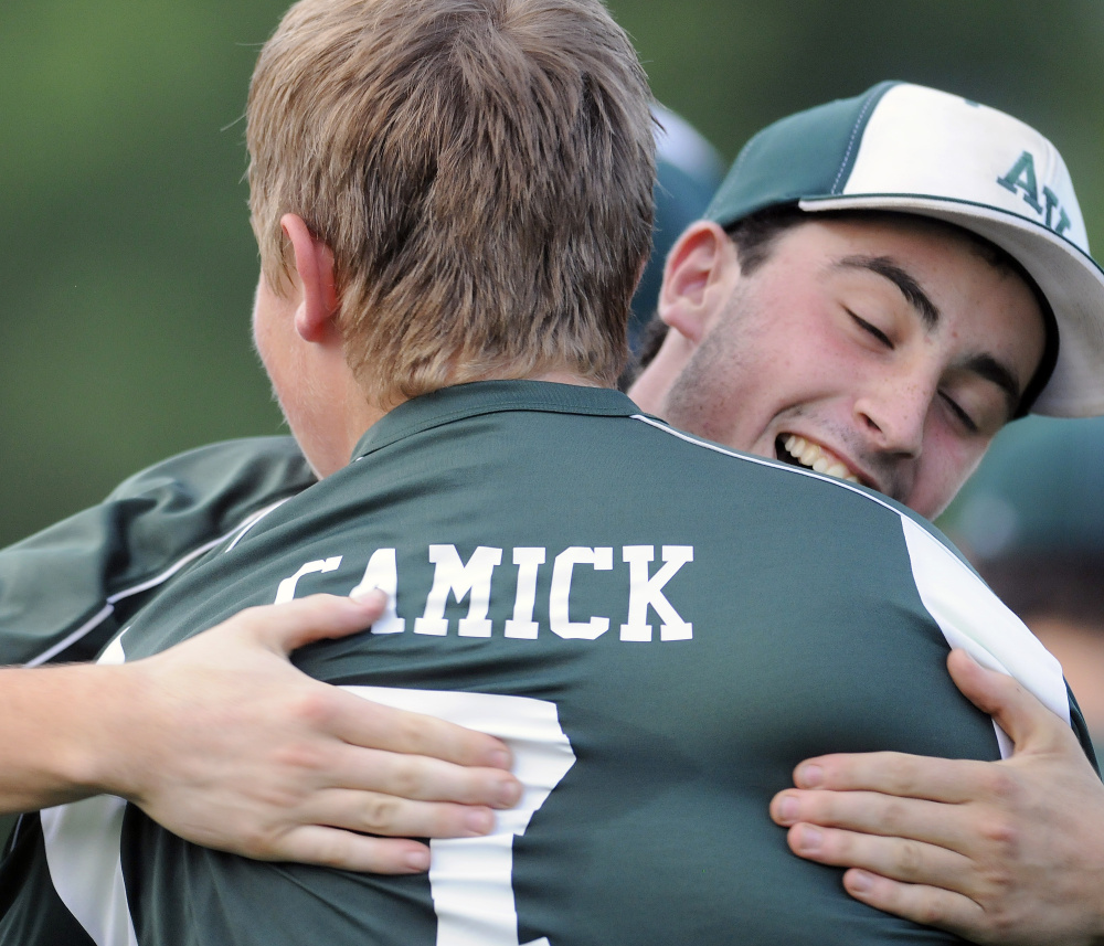 Apple Valley's Jackson Ladd, right, hugs teammate Carson Camick after they defeated Tri County in the 13-15 Babe Ruth state championship game Monday night in Augusta.