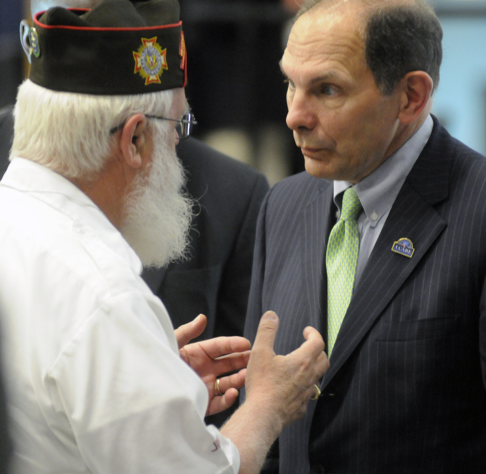 U.S. Veterans Affairs Secretary Robert McDonald speaks with Maine VFW member James Bachelder on Thursday during the Maine Military & Community Network conference in Augusta.