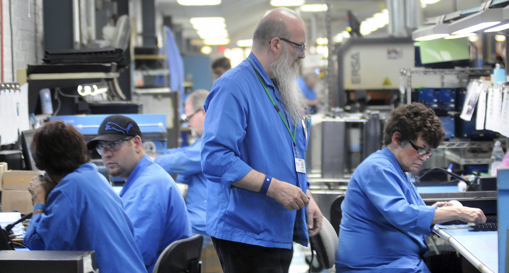 Workers assemble products at Alternative Manufacturing Inc. in Winthrop Wednesday.