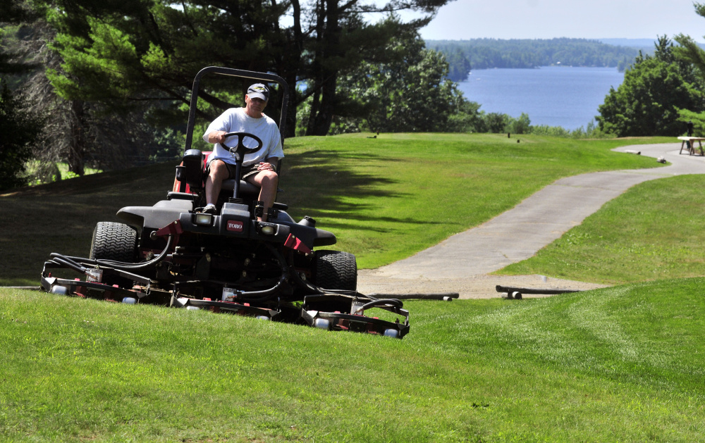 Mike Nadeau drives a rough mower at the Augusta Country Club on Wednesday in Manchester. A lot of prep work goes into getting the course ready for a big tournament like the Charlie's Maine Open that gets under way Monday.
