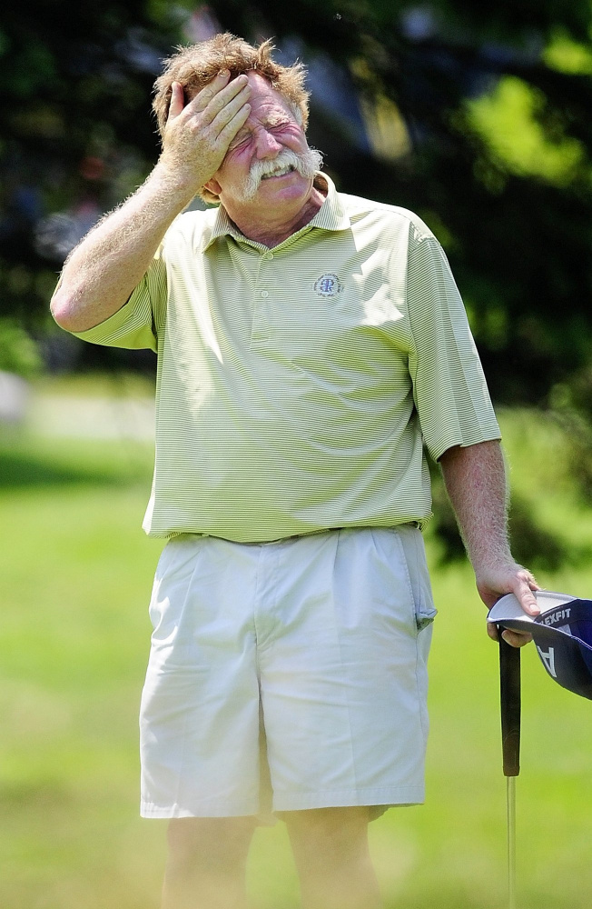 Mark Plummer mops his brows after finishing the first nine holes on the second day of a Charlie's Maine Open Championship at the Augusta Country Club.