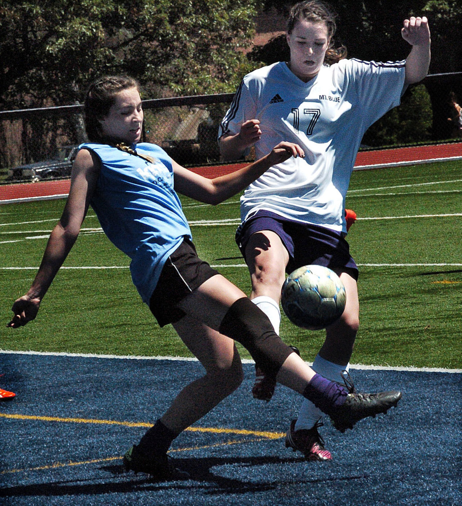 Staff photo by David Leaming
Waterville's Lily Foster, left, and Mt. Blue's  Miranda Nicely battle for possession during a benefit soccer game at Colby College on Sunday to honor former Messalonskee student Cassidy Charette.