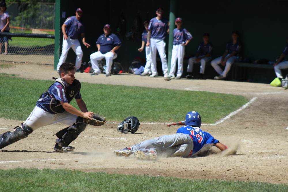 Augusta 13's baserunner Akira Warren slides in safely to score a run during a New England regional pool play game against Pittsfield, Massachusetts, in Rochester, New Hampshire on Monday morning. Augusta fell, 6-1.