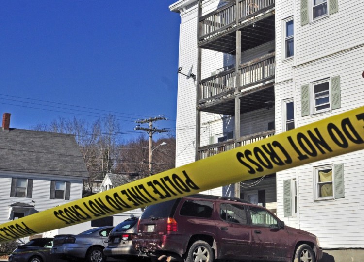 Police tape surrounds the parking lot at 75 Washington St. in November 2015 in Augusta after Joseph Marceau, 31, of Augusta, was found dead in an apartment in the building at right.
