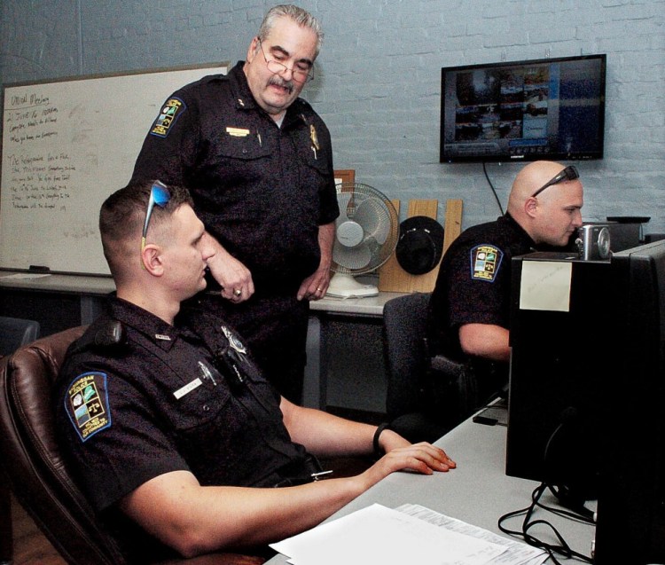 Skowhegan police Chief Don Bolduc, center, oversees officers C.J. Vera, left, and Ian Shalit filling out police reports in June. Skowhegan officers defused a situation Monday in which deadly force was "clearly justified," Bolduc said Monday. He didn't say which officers were involved in the encounter.