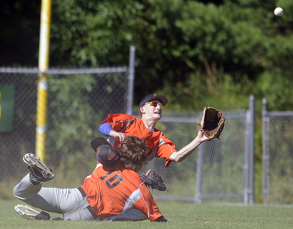 Skowhegan's Evan Bess, right, gets ready to catch a pop up after colliding with teammate Adam Turcotte in right field against Yankee Ford during the American Legion state tournament Wednesday in Augusta.