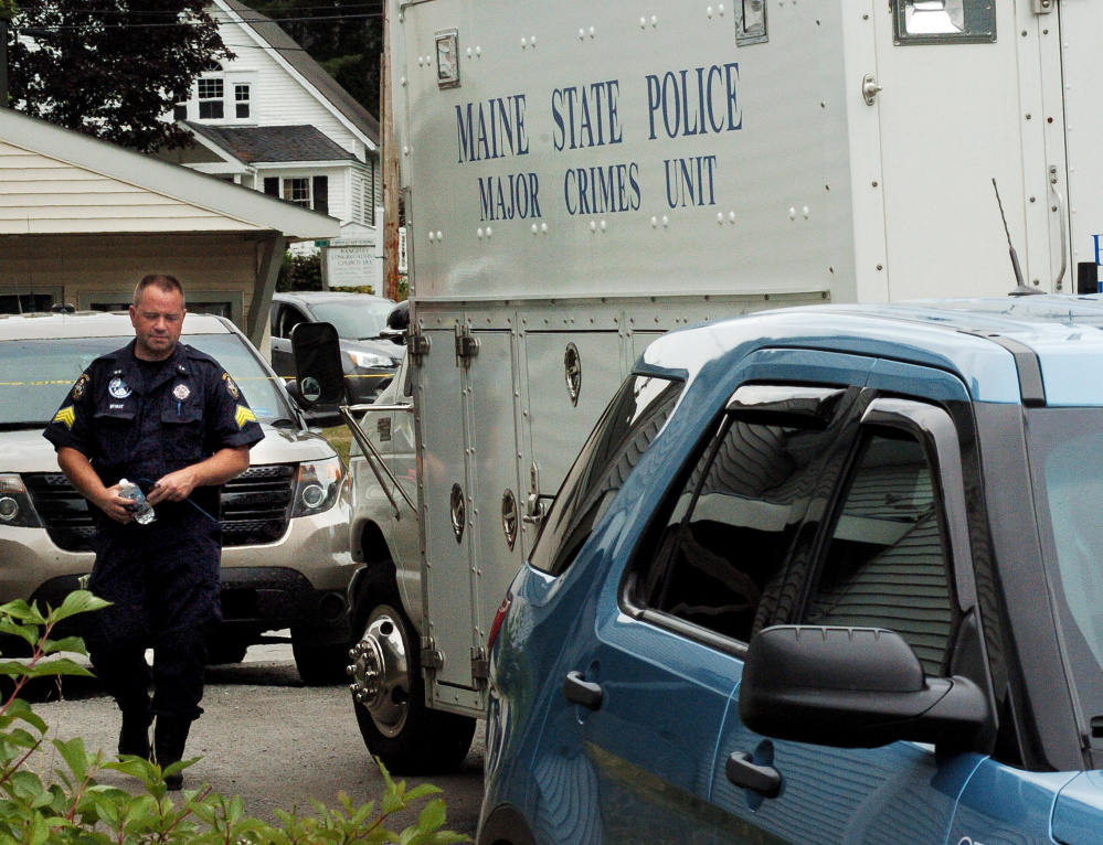 Maine State Police Sgt. Scott Bryant enters the department's Major Crimes Unit on Thursday near the scene of a possible home invasion that left one man dead and two injured in Rangeley.