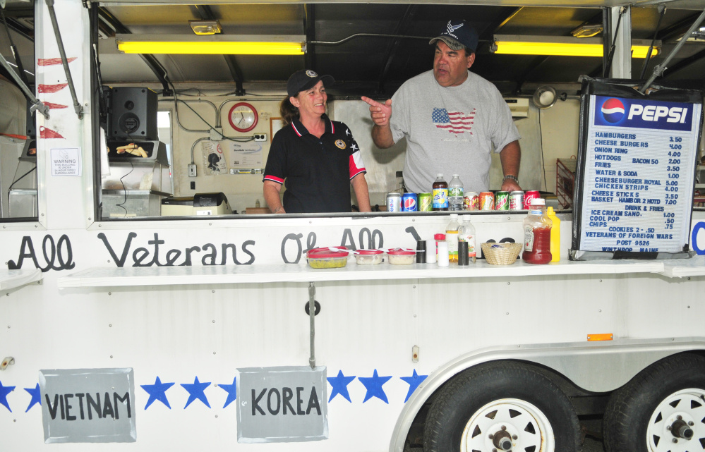 Tina Bowden, left, and John Brennan, volunteers with local veterans' organizations, talk about recent vandalism to a snack shack during an interview Friday on the shore of Maranacook Lake in Winthrop.