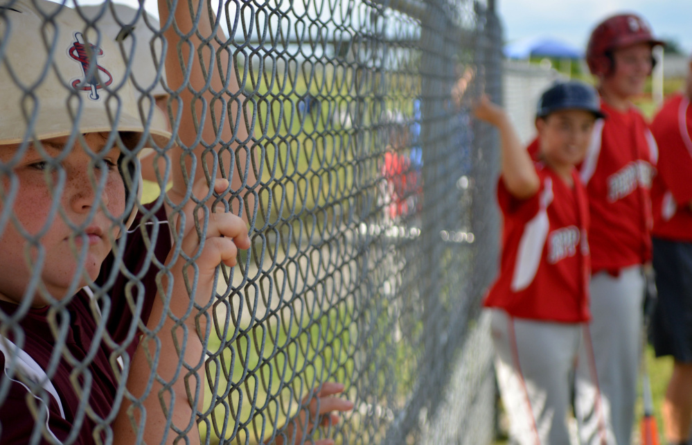  Jake Hayes, 11, from Chelmsford, Massachusetts, far left, watches the Cal Ripken U12 home run derby at Carl Wright Complex in Skowhegan on Friday.