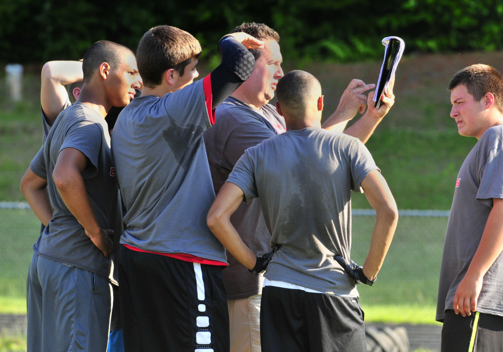 Cony football coach calls a play during a 7-on-7 game against Maranacook on Friday in Turner.