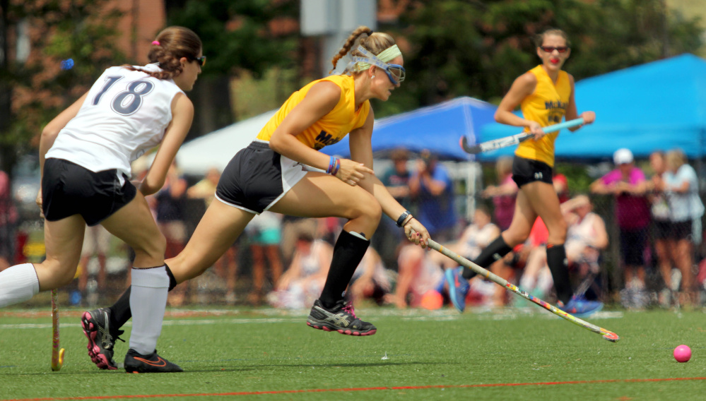 Messalonskee's Riley Field, playing for the North, races to the ball by the South's Hayley Peterson of Telstar at the McNally Senior All-Star game Saturday at Thomas College in Waterville.