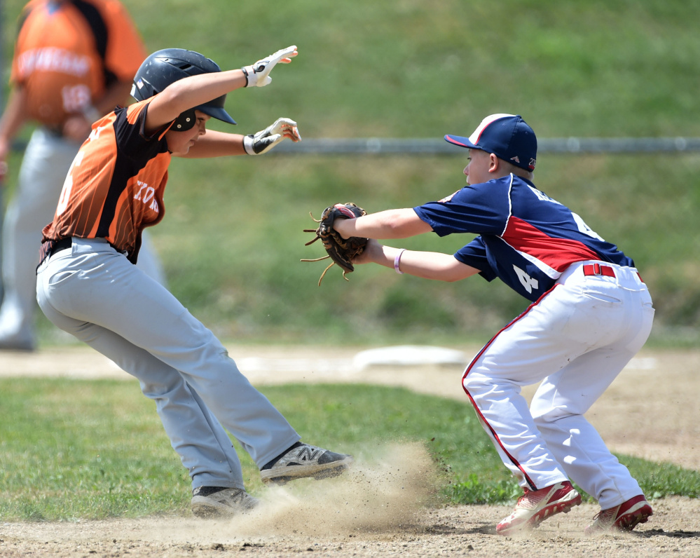 Skowhegan's Hunter McEwen (6) gets caught in a pickle by Freetown/Lakeville's Curt Heath during the 11-year-old Cal Ripken New England tournament Saturday at Carl Wright Complex in Skowhegan.