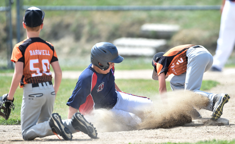 Freetown/Lakeville's Maddoxx Rosyski (8) slides safely into second base before Skowhegan's Brayden Saucier (2) can make the play during the 11-year-old Cal Ripken New England tournament Saturday at Carl Wright Complex in Skowhegan.