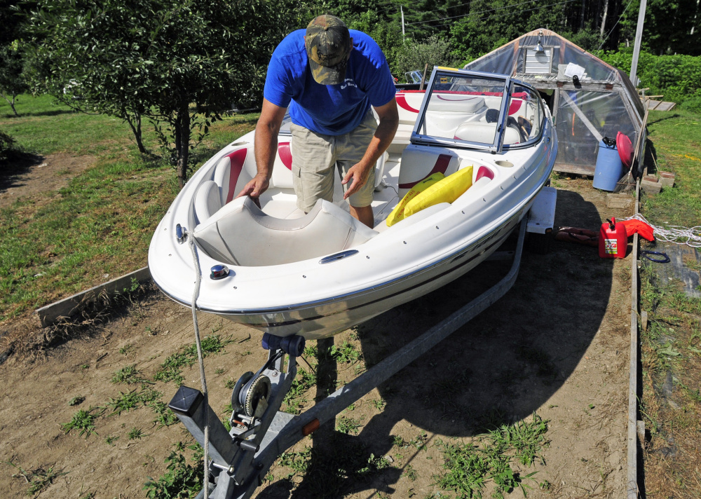 Gary Sawtelle cleans up a boat Saturday. It was returning from being rented out at Beacon Boat Rental in Wayne.