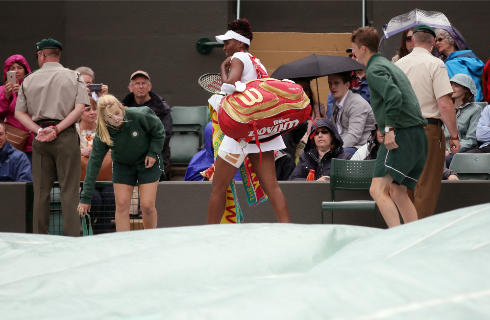 Venus Williams of the U.S leaves the court after rain delayed her women's singles match against Daria Kasatkina of Russia on day five of the Wimbledon Tennis Championships in London Friday, July 1, 2016. (AP Photo/Tim Ireland)