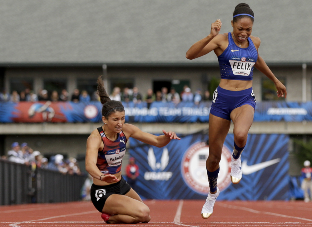 Jenna Prandini, left, dives across the finish line to claim the third spot on the U.S. Olympic team in the 200 meters – .01 second ahead of the 2012 Olympic champion Allyson Felix.
