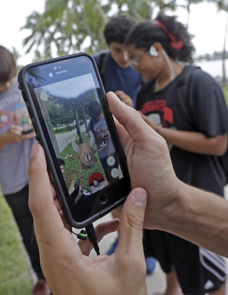 Pinsir, a Pokemon, is found by a group of "Pokemon Go" players at Bayfront Park in downtown Miami on Tuesday.