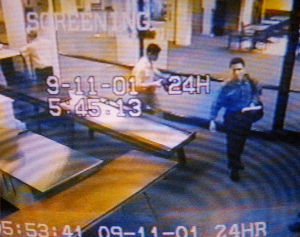 An airport surveillance tape shows two men, identified by authorities as suspected hijackers Mohamed Atta, right, and Abdulaziz Alomari, center, passing through airport security at Portland International Jetport before boarding a commuter flight to Boston for American Airlines Flight 11, which was one of two jetliners crashed into the World Trade Center. A once-classified section of the inquiry is expected to released publicly Friday.