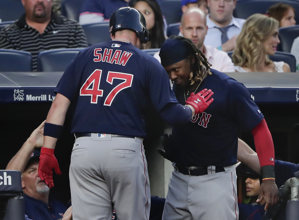 Boston's Travis Shaw celebrates with Hanley Ramirez after hitting a two-run home run against the New York Yankees in the fifth inning Friday night in New York.