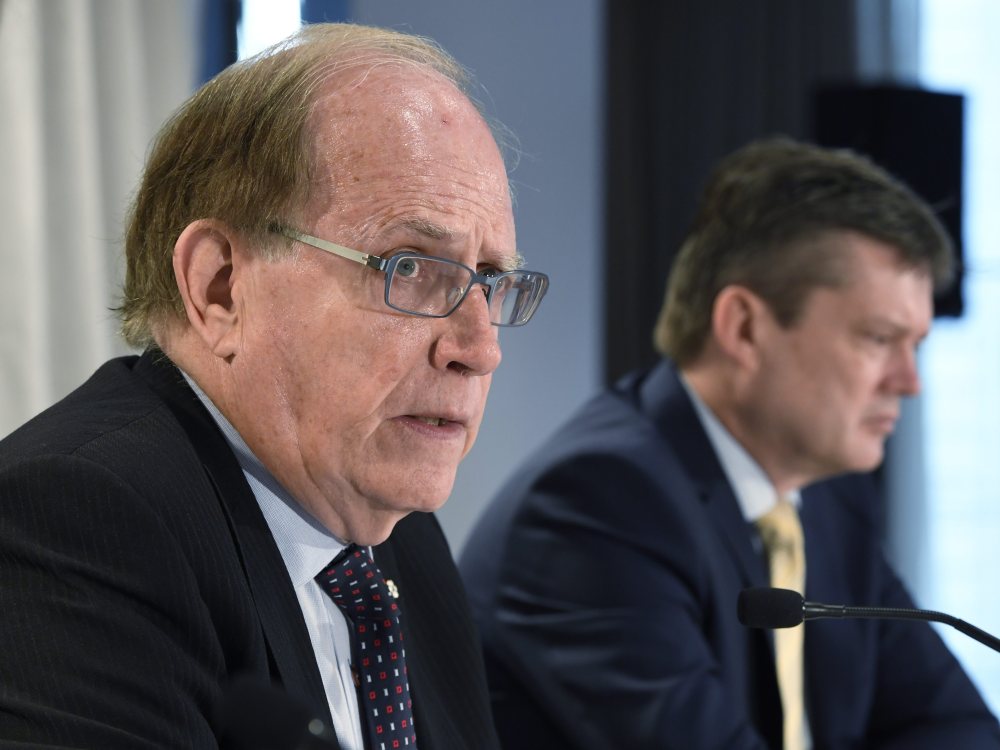 Canadian law professor Richard McLaren, left, and investigator Martin Dubbey are shown at a news conference to present McLaren's findings into allegations of a state-backed doping conspiracy involving the 2014 Winter Olympics in Sochi, Russia, in Toronto, Monday, July 18, 2016.
