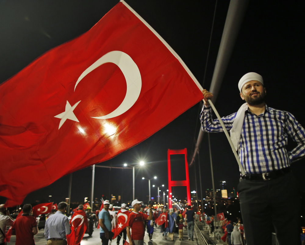 A pro-government supporter waves a Turkish flag Thursday during a demonstration on the road leading to Istanbul's iconic Bosporus Bridge.