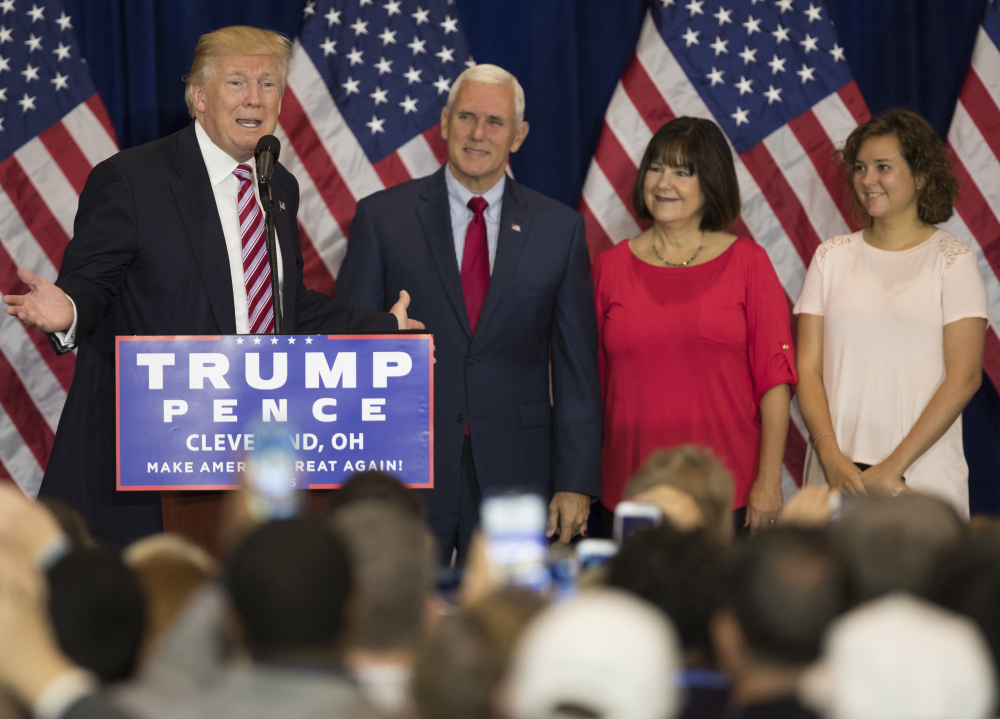 Republican presidential nominee Donald Trump speaks at a reception after the Republican National Convention on Friday in Cleveland. Listening are vice presidential running mate Gov. Mike Pence, R-Ind., Karen Pence, and Charlotte Pence.