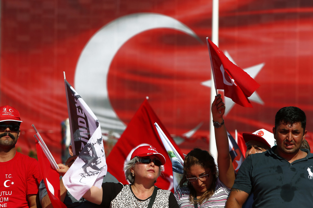 Supporters of the Republican People's Party wave Turkish flags during a 'Republic and Democracy Rally' at Taksim square in central Istanbul on Sunday.