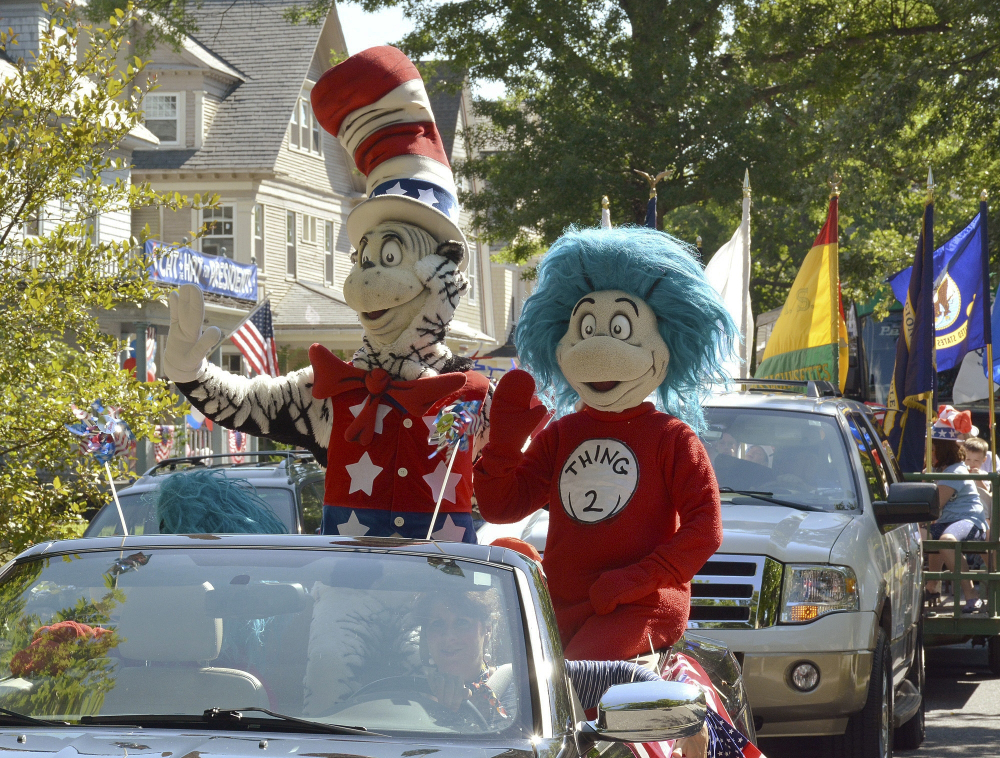 A character portraying the Cat in the Hat parades with Thing 2 on Tuesday after he declared he is running for president, outside the childhood home of their creator Theodor Geisel, better known as Dr. Seuss, on Fairfield Street in Springfield, Mass.