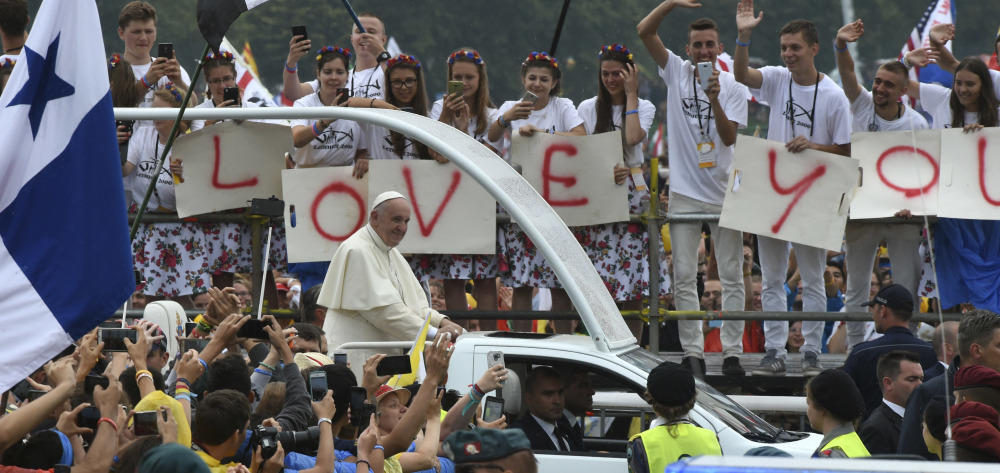 Faithful participating in the World Youth Days wave to Pope Francis on his popemobile in Krakow's Jordan Park in Poland on Thursday. The Pope is on a five-day visit to Poland which will culminate with the World Youth Day on Sunday.