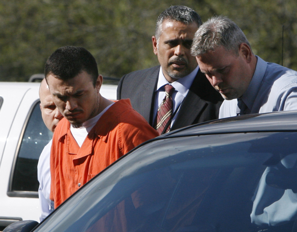 Ingmar Guandique is escorted detectives in 2009. He was convicted of Levy's murder in 2010. On Thursday, all charges against him were dropped.
Associated Press/Jacquelyn Martin