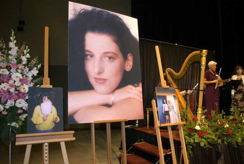 Photos of Chandra Levy are on display at her memorial service in 2002. Police initially had suspected then-California Rep. Gary Condit in her killing.