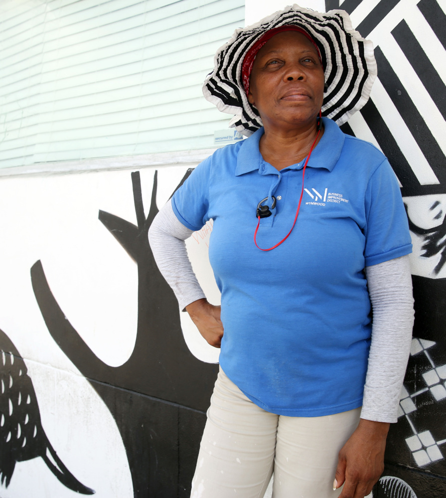 Glendina Rosebo takes a break from cleaning the sidewalks in the Wynwood area of Miami on Friday, where four patients were infected with Zika.