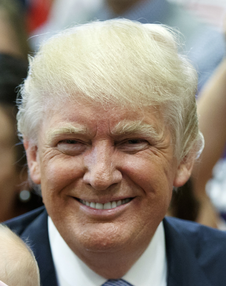 Republican presidential candidate Donald Trump poses for photographs with a pair of babies during a campaign rally, Friday, July 29, 2016, in Colorado Springs, Colo. (AP Photo/Evan Vucci)