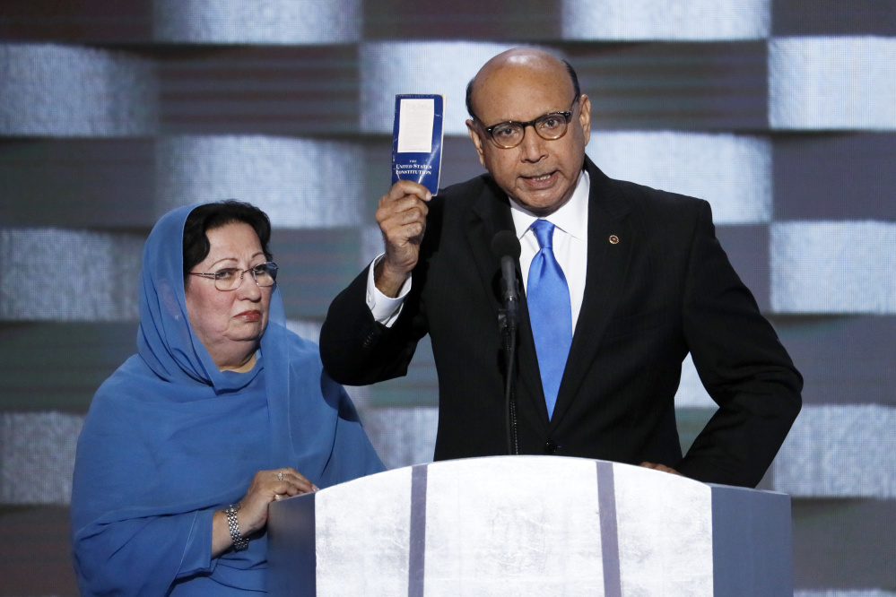 Khizr Khan, father of fallen Army Capt. Humayun S. M. Khan, holds up a copy of the Constitution of the United States as his wife listens during the final day of the Democratic National Convention in Philadelphia.
Associated Press/J. Scott Applewhite