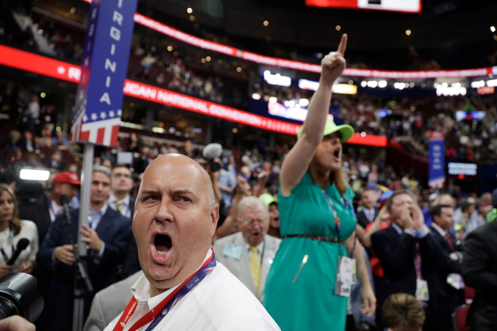 Illinois delegate Christian Gramm, left, and other delegates react Monday as some call for a roll call vote on the adoption of the rules during first day of the Republican National Convention in Cleveland.
