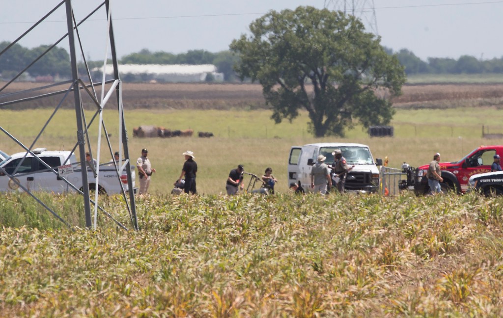 The partial frame of a hot air balloon is visible at the scene in a field near Lockhart, Texas, where a hot air balloon carrying at least 16 people collided with power lines Saturday, causing what authorities described as a "significant loss of life."  
Ralph Barrera/Austin American-Statesman via AP