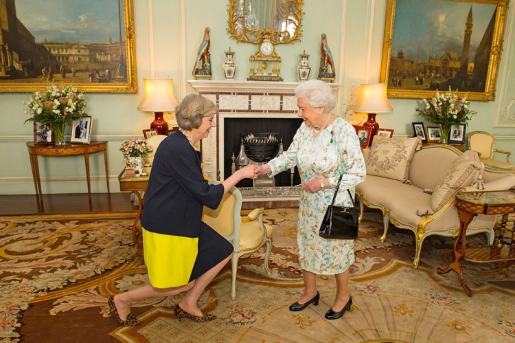 Queen Elizabeth II welcomes Theresa May at the start of an audience in Buckingham Palace, where she invited the former home secretary to become prime minister and form a new government. Dominic Lipinski via AP