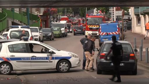 Police speak to a driver as they close a road during a hostage situation in Rouen, in Normandy, France, on Tuesday. (BFM screen image via )AP