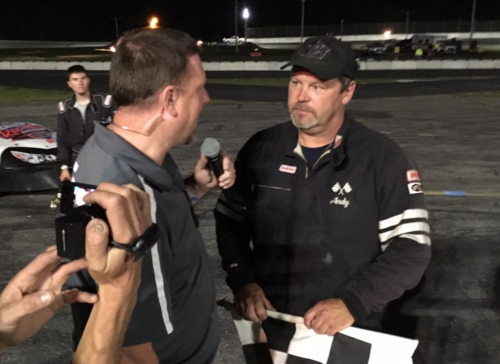 Wiscasset Speedway track announcer Ken Minott, left, interviews Andy Saunders of Ellsworth after Saunders won the track's Pro Stock feature Saturday night.