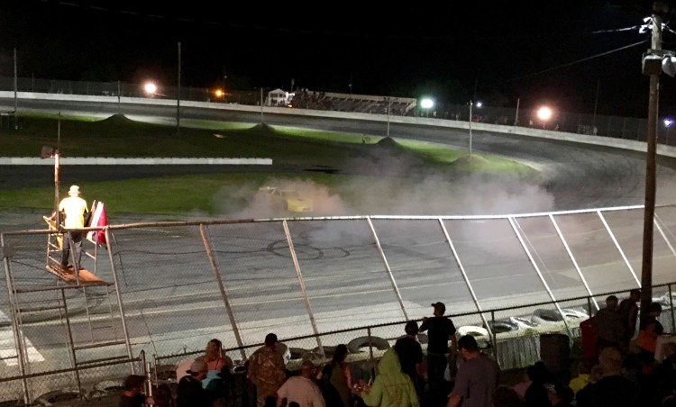 Dave St. Clair, 68, of Liberty, celebrates his win Saturday night at Wiscasset Speedway with a smoky burnout on the track's frontstretch.
