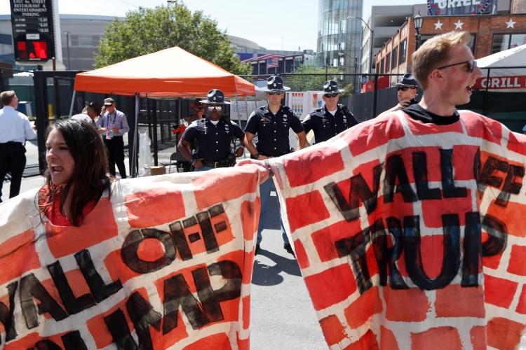 Immigrant rights activists protest Republican presidential candidate Donald Trump's stated intention to build a wall at the Mexican border to keep out illegal immigrants. John Minchillo/Associated Press