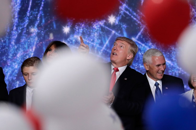 Donald Trump looks up at falling balloons as he stands on the stage with his son Barron, wife Melania and vice presidential nominee Mike Pence after his acceptance speech Thursday night.
Associated Press/J. Scott Applewhite