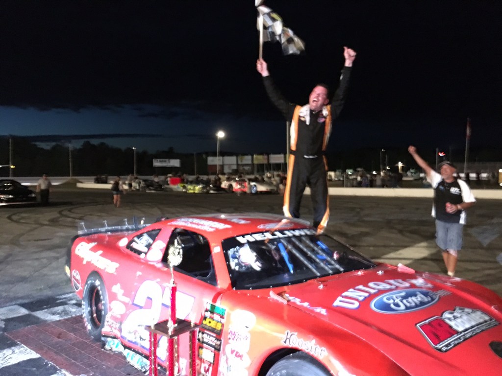 Wayne Helliwell Jr. of Dover, New Hampshire, celebrates winning the PASS HP Hood 150 on Sunday night at Oxford Plains Speedway in Oxford.