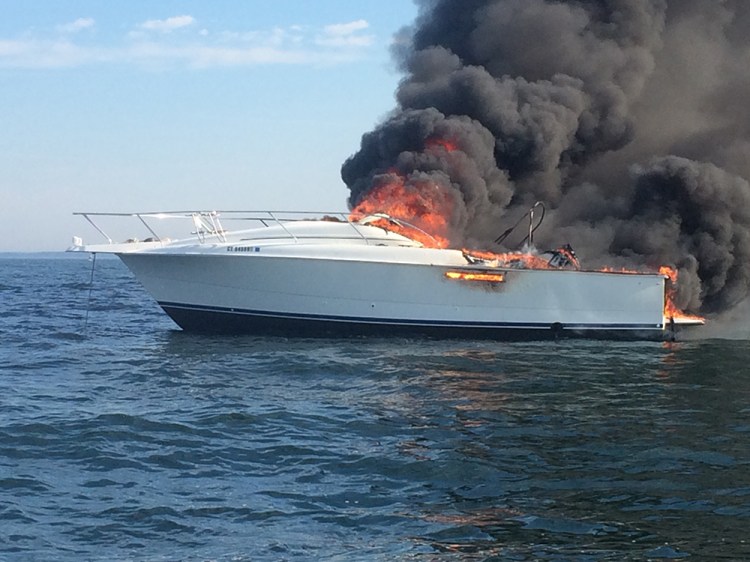 A 31-foot motor boat belonging to Timothy Lenz of Westport burns near Wood Island, off the coast of Saco, Tuesday. The boat eventually sank in about 100 feet of water. Maine Marine Patrol photo
 
 