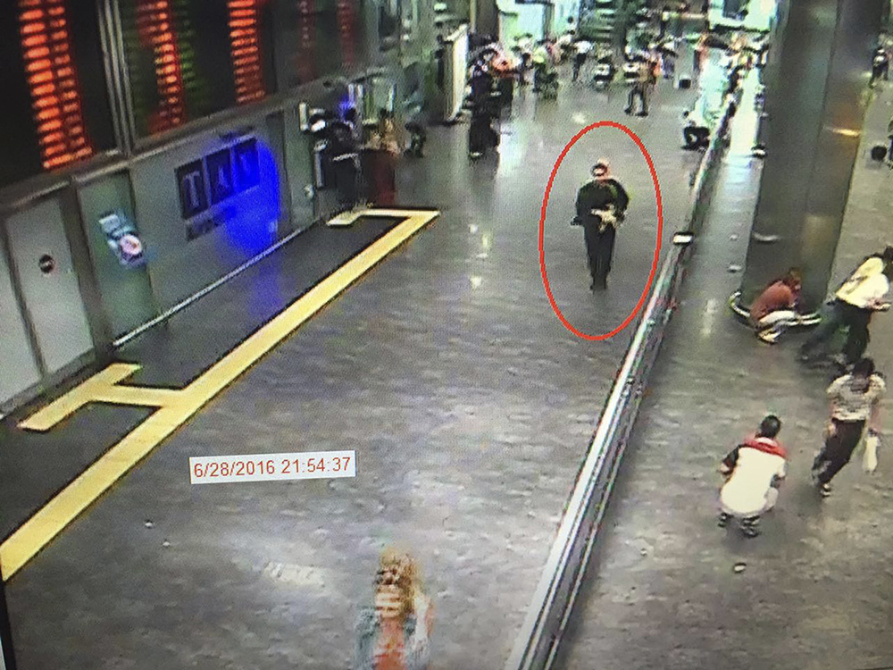 A man, circled, is believed to be among the attackers who carried out a gun-and-suicide bomb attack at Attaturk airport, killing dozens and wounding scores of others late Tuesday. Video framegrab from CCTV  made available by the Turkish Haberturk newspaper.