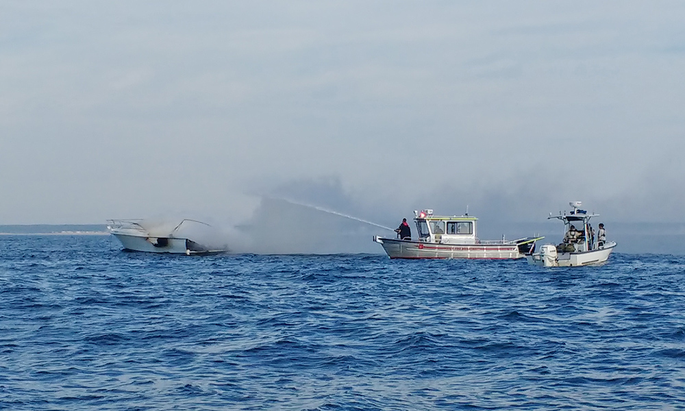 Saco Fire Department personnel attempt to extinguish the boat fire Tuesday morning.